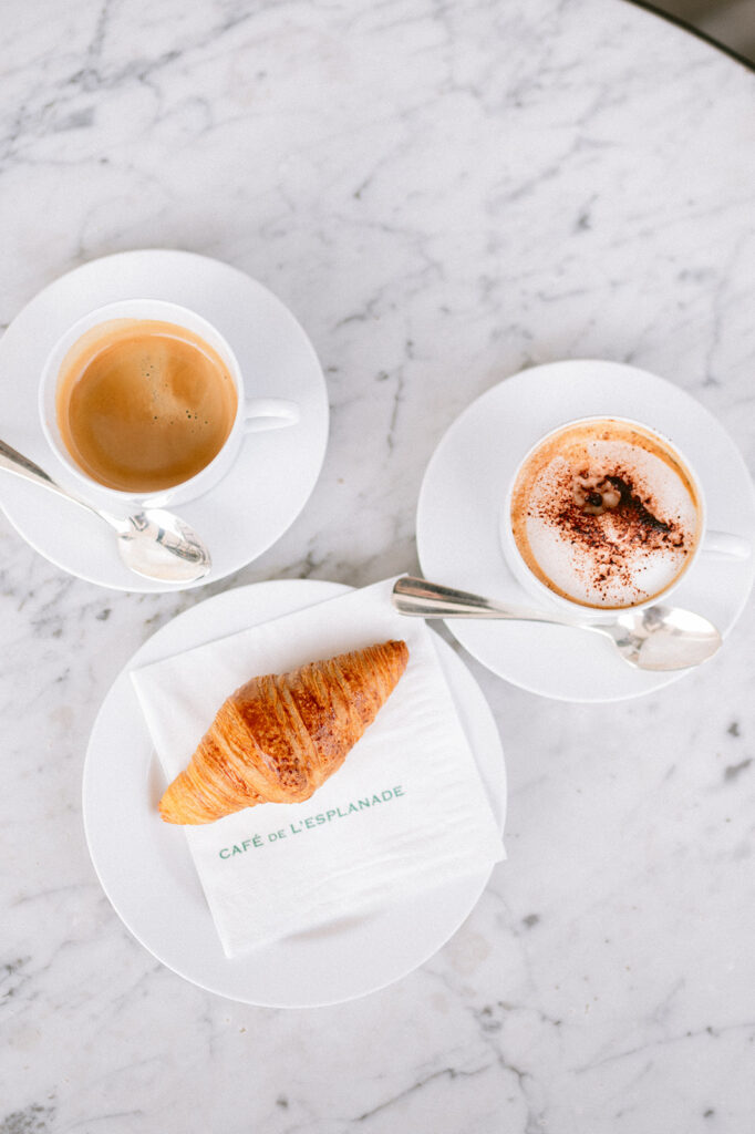 Romantic couple enjoying coffee at a Paris café photoshoot